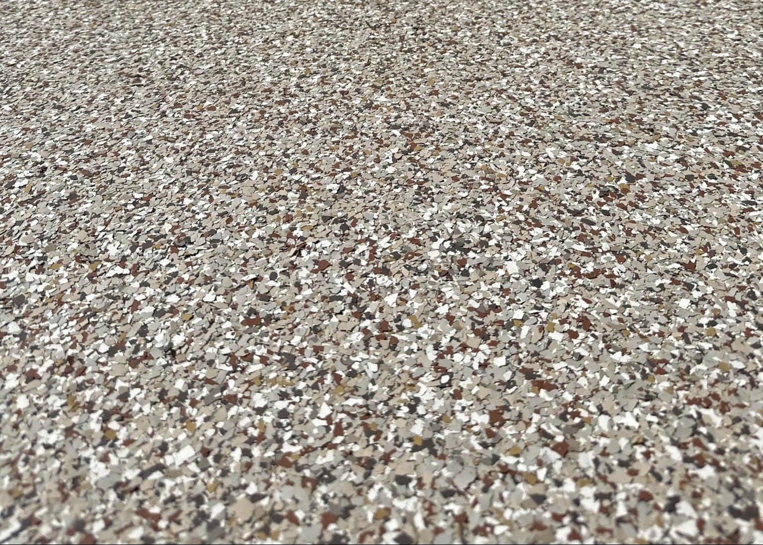 Close-up of a textured concrete surface with a building in the background