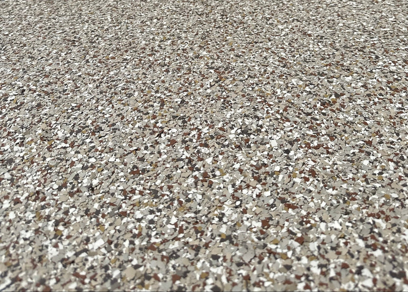 Close-up of a textured concrete surface with a building in the background