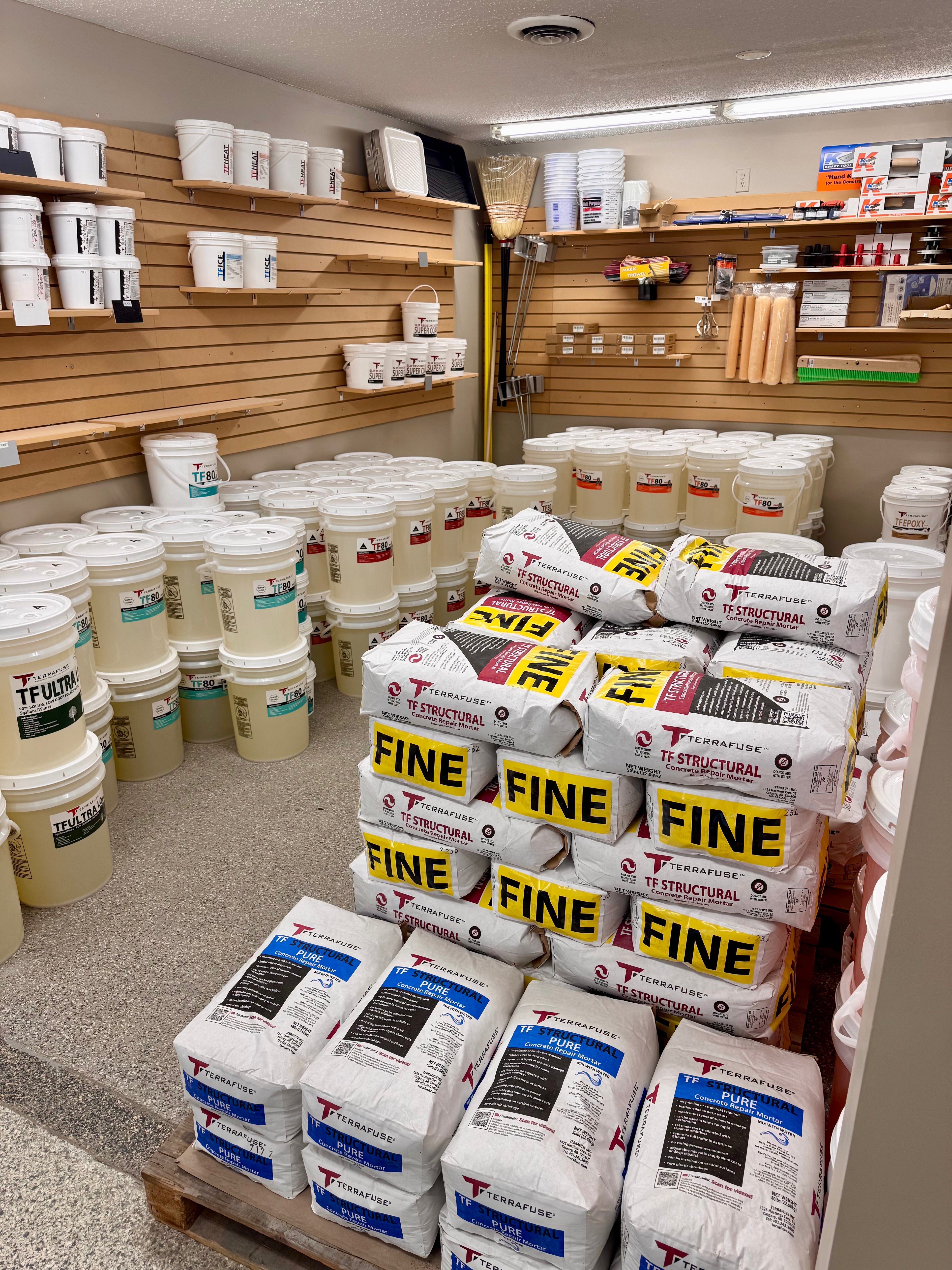 Terrafuse Shop with stacks of concrete bags labeled 'FINE' and 'STRUCTURAL' on pallets.